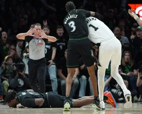 Naz Reid falls to the court after he was fouled by Victor Wembanyama on Sunday